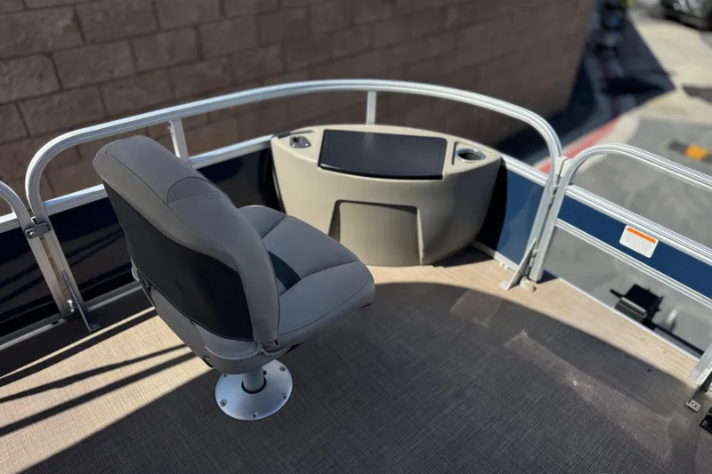 Slide: The Image of 2024 Sun Tracker Bass Buggy 18 DLX boat interior with captain's chair and console. - 11