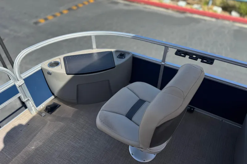 Slide: The Image of 2024 Sun Tracker Bass Buggy 18 DLX boat interior with captain's chair and console. - 12