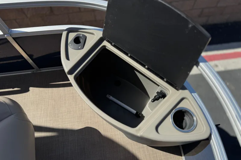 Slide: The Image of Open storage compartment on 2024 Sun Tracker Bass Buggy 18 DLX pontoon boat. - 13