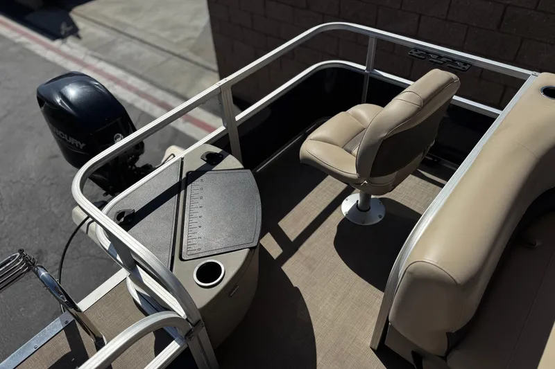 Slide: The Image of 2024 Sun Tracker Bass Buggy 18 DLX pontoon boat interior with seating and fishing station. - 19