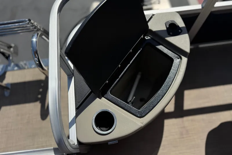 Slide: The Image of 2024 Sun Tracker Bass Buggy 18 DLX storage compartment with cup holder, open lid view. - 20