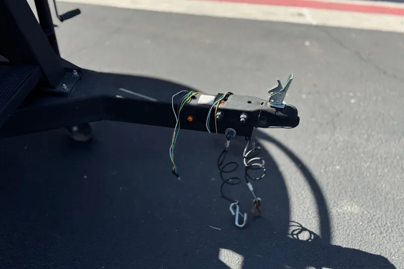 Slide: The Image of Trailer hitch of 2024 Sun Tracker Bass Buggy 18 DLX on asphalt surface. - 29