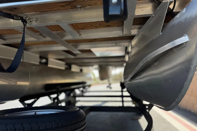 Slide: The Image of Underneath view of 2024 Sun Tracker Bass Buggy 18 DLX pontoon boat on trailer. - 4