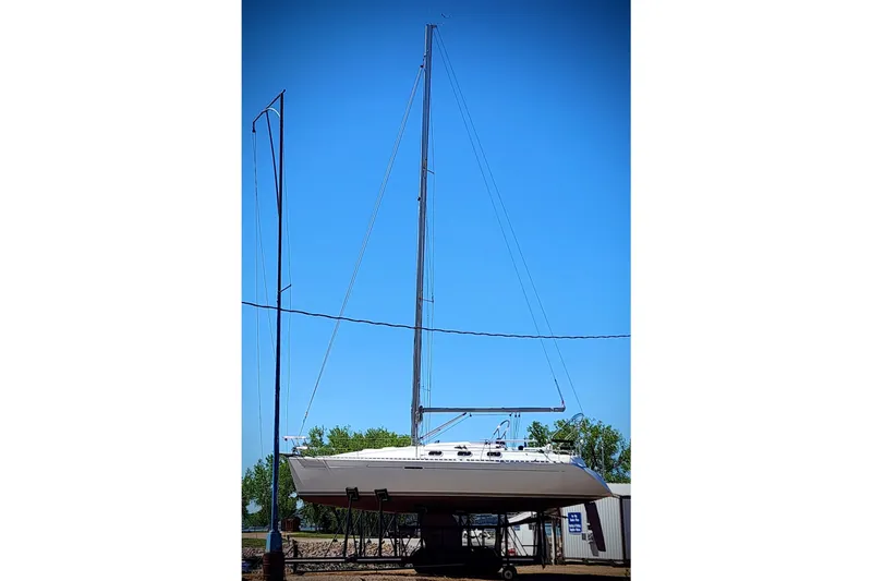 Slide: The Image of 1997 Beneteau First 36s7 sailboat on dry dock under clear blue sky. - 15