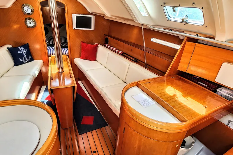 Slide: The Image of Interior of a 1997 Beneteau First 36s7 sailboat with elegant wood finish and cozy seating. - 4