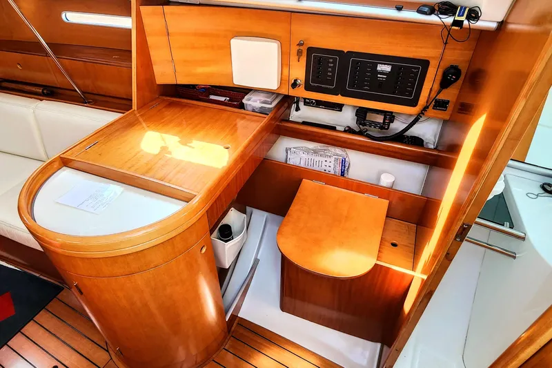 Slide: The Image of Interior of a 1997 Beneteau First 36s7 sailboat with wooden cabinetry and navigation equipment. - 5