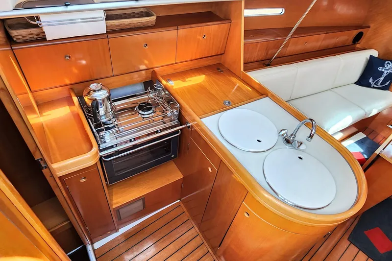Slide: The Image of Luxurious 1997 Beneteau First 36s7 yacht interior with modern kitchen and cozy seating area. - 6