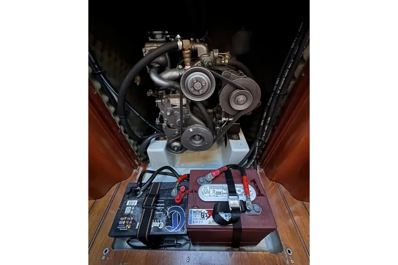 Slide: The Image of Engine compartment of a 1997 Beneteau First 36s7 sailboat, featuring battery and mechanical components. - 9