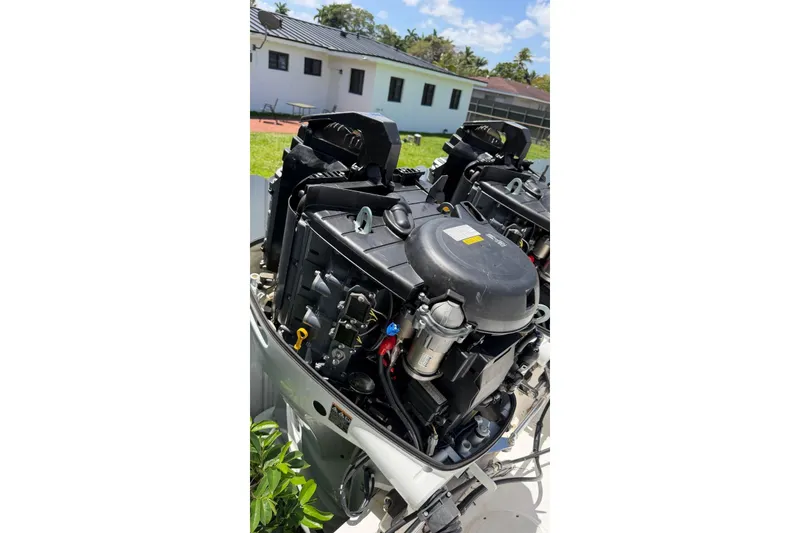 Slide: The Image of Outboard engines of a 2006 Intrepid 348 Walkaround boat in a sunny yard. - 13
