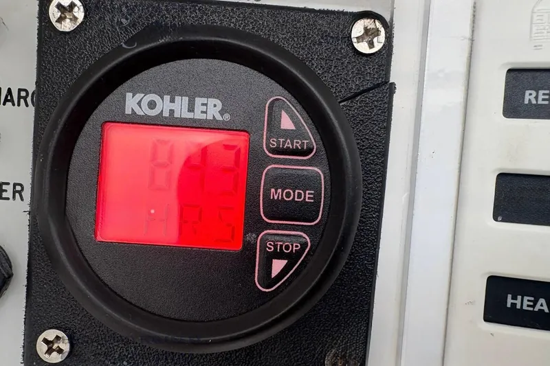 Slide: The Image of Kohler control panel displaying 843 hours on a 2006 Intrepid 348 Walkaround boat. - 19