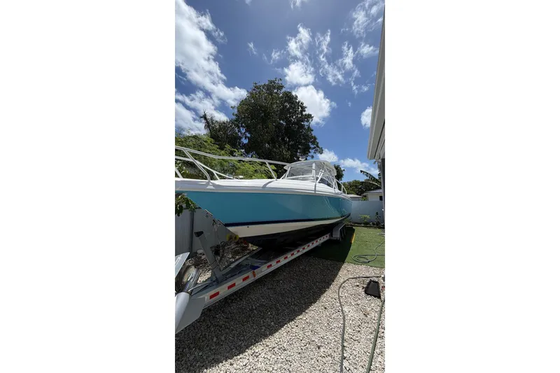 Slide: The Image of 2006 Intrepid 348 Walkaround boat on trailer under clear blue sky. - 2