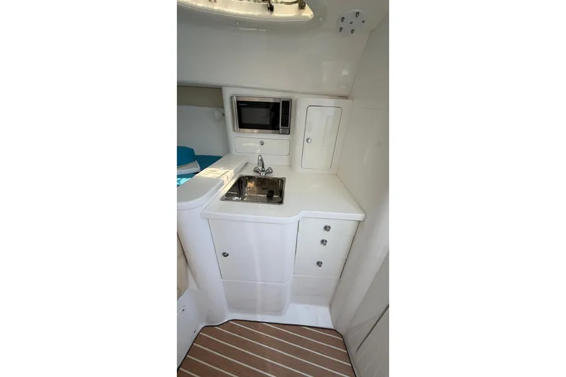 Slide: The Image of Compact galley in 2006 Intrepid 348 Walkaround boat with sink and microwave. - 3