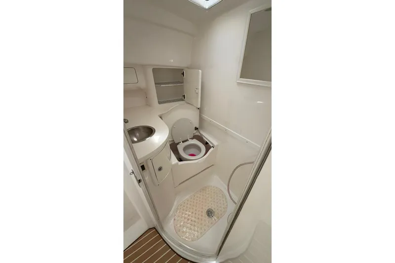 Slide: The Image of Bathroom interior of 2006 Intrepid 348 Walkaround boat, featuring sink and toilet. - 6