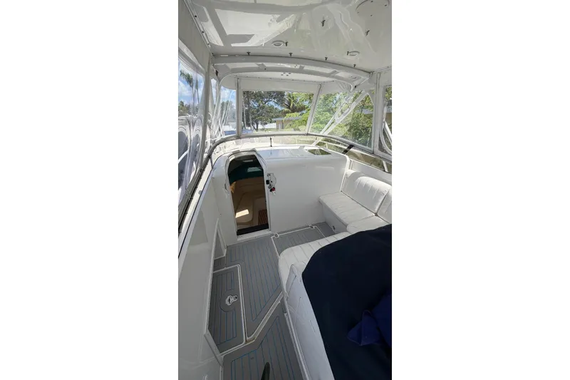 Slide: The Image of 2006 Intrepid 348 Walkaround boat interior with seating and cabin entrance. - 7