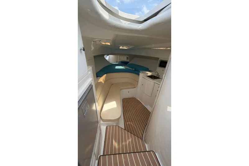 Slide: The Image of Interior of 2006 Intrepid 348 Walkaround boat with seating and kitchenette. - 8