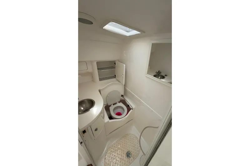 Slide: The Image of 2006 Intrepid 348 Walkaround boat bathroom with sink, toilet, and storage. - 9