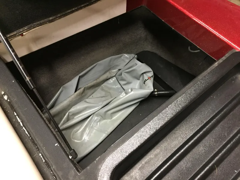 Slide: The Image of Storage compartment in 2013 Malibu Wakesetter 23 LSV with gray cover. - 15
