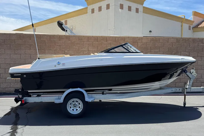 The Image of 2022 Bayliner VR4 Bowrider I/O on trailer, parked outdoors against a brick wall. - 0