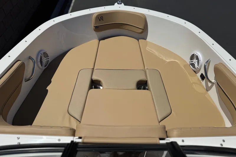 Slide: The Image of 2022 Bayliner VR4 Bowrider I/O boat interior with beige seating and speakers. - 10
