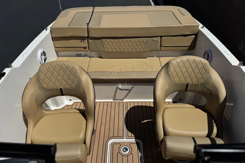Slide: The Image of 2022 Bayliner VR4 Bowrider I/O interior with tan seating and wood-style flooring. - 12