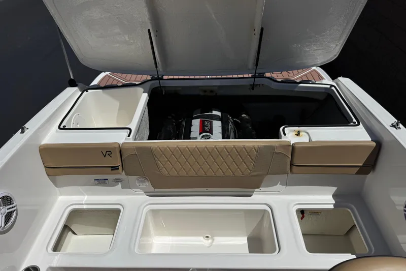 Slide: The Image of 2022 Bayliner VR4 Bowrider I/O engine compartment with open hatch and storage areas. - 13