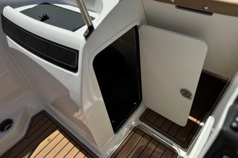 Slide: The Image of 2022 Bayliner VR4 Bowrider I/O interior storage compartment with open door and wood flooring. - 19