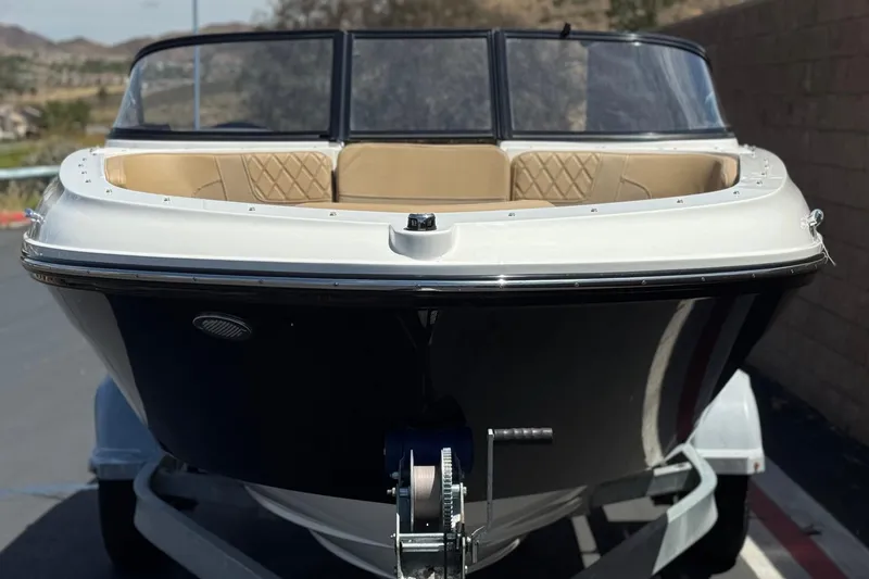 Slide: The Image of 2022 Bayliner VR4 Bowrider I/O boat on trailer, front view, beige interior. - 2