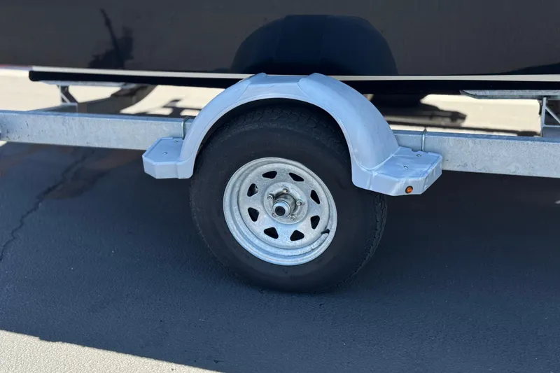 Slide: The Image of Trailer wheel of 2022 Bayliner VR4 Bowrider I/O on pavement. - 22