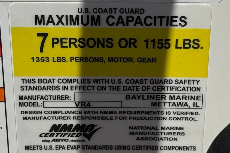 Slide: The Image of 2022 Bayliner VR4 Bowrider I/O capacity label: 7 persons or 1155 lbs, USCG compliant. - 24