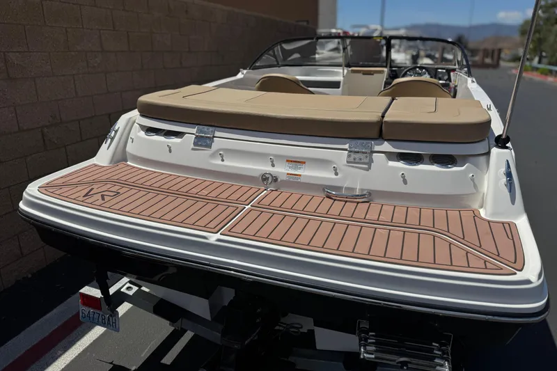 Slide: The Image of 2022 Bayliner VR4 Bowrider I/O with tan seating and wood-patterned deck. - 6