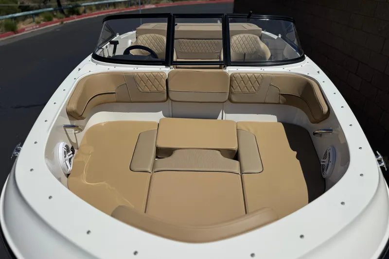 Slide: The Image of 2022 Bayliner VR4 Bowrider I/O with beige seating and spacious interior design. - 9