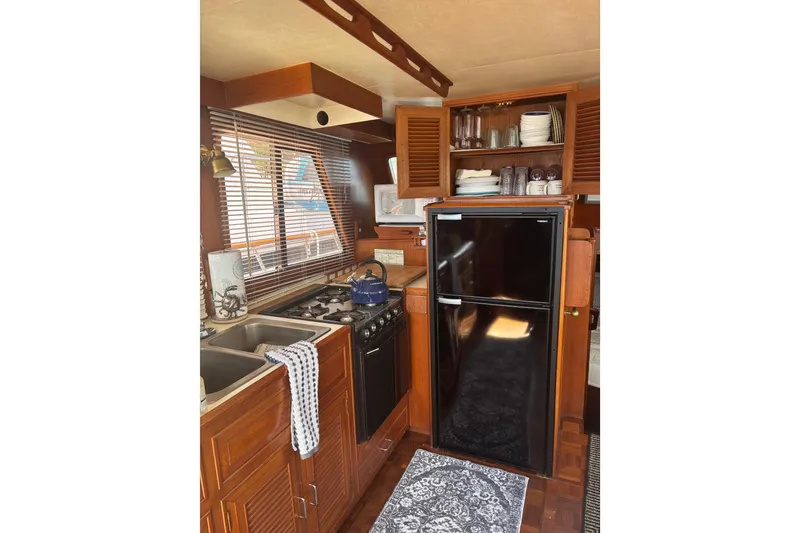 Slide: The Image of 1984 Ocean Alexander 38 Double Cabin kitchen with wooden cabinetry and modern appliances. - 10