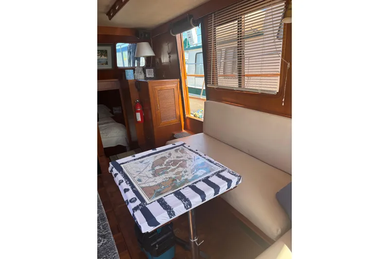 Slide: The Image of Interior of 1984 Ocean Alexander 38 Double Cabin with cozy seating and nautical decor. - 13