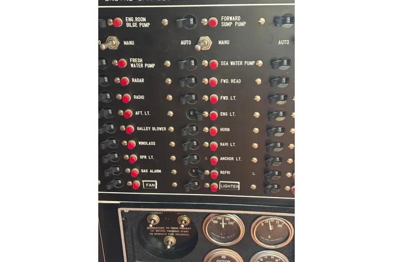 Slide: The Image of Control panel of a 1984 Ocean Alexander 38 Double Cabin yacht with various switches and gauges. - 16