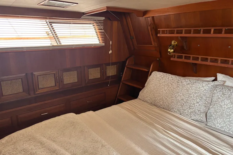 Slide: The Image of Cozy cabin interior of 1984 Ocean Alexander 38 Double Cabin with wood paneling and bed. - 18