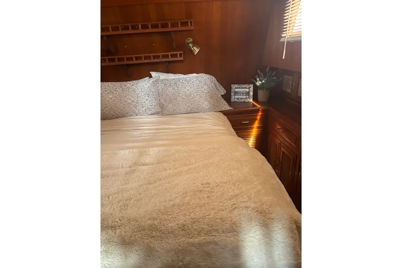 Slide: The Image of Cozy bedroom interior of 1984 Ocean Alexander 38 Double Cabin yacht with wooden accents. - 19