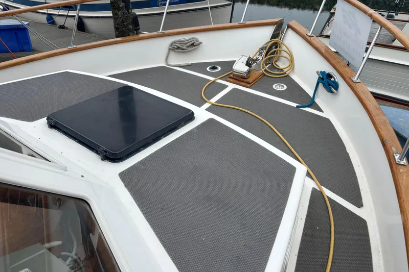 Slide: The Image of 1984 Ocean Alexander 38 Double Cabin deck with hatch, ropes, and wooden railings. - 2