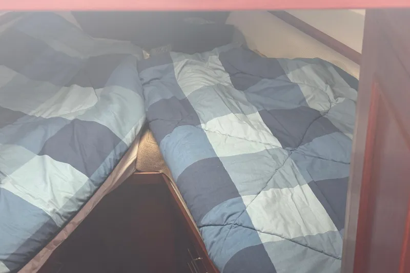 Slide: The Image of Twin beds with blue checkered bedding in 1984 Ocean Alexander 38 Double Cabin. - 23