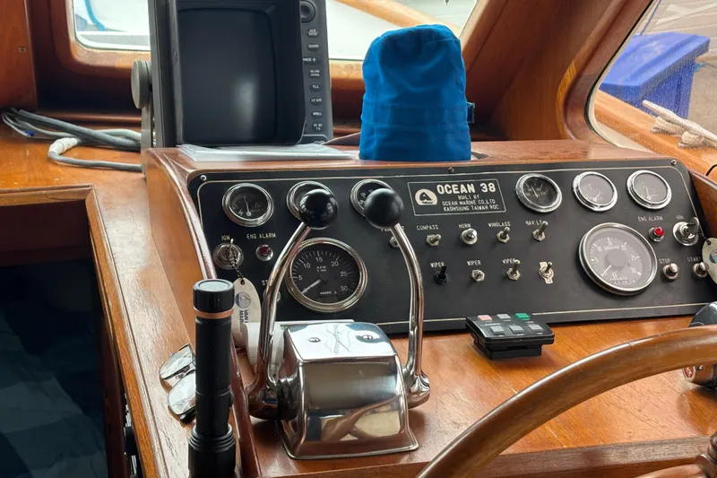 Slide: The Image of 1984 Ocean Alexander 38 Double Cabin helm with gauges and controls. - 25