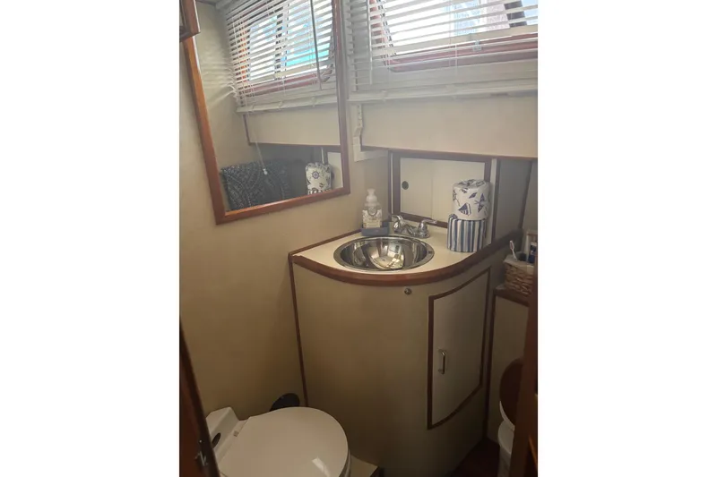 Slide: The Image of 1984 Ocean Alexander 38 Double Cabin bathroom with sink, mirror, and toilet. - 30