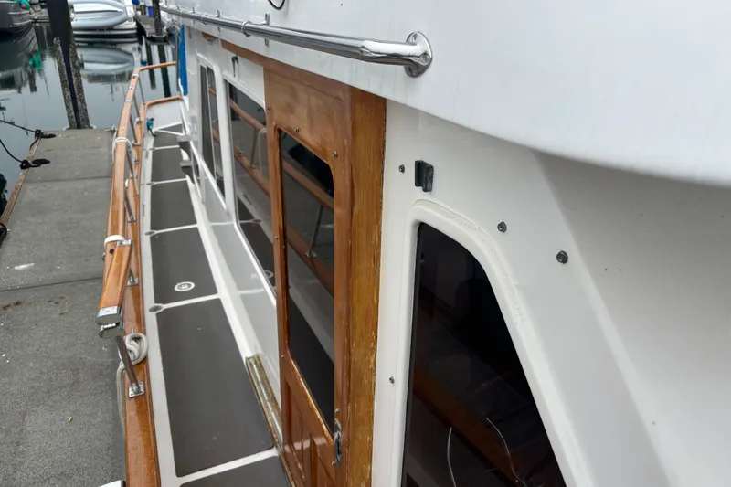 Slide: The Image of 1984 Ocean Alexander 38 Double Cabin yacht with wooden accents docked at marina. - 4