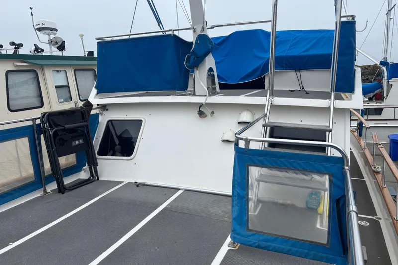 Slide: The Image of 1984 Ocean Alexander 38 Double Cabin yacht with blue covers and deck chairs. - 7