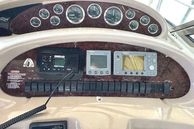 Slide: The Image of Control panel of a 2001 Sea Ray 380 Sundancer with navigation instruments and gauges. - 11