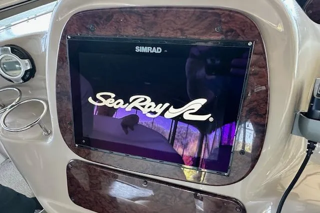 Slide: The Image of Simrad display on 2001 Sea Ray 380 Sundancer dashboard with logo visible. - 12