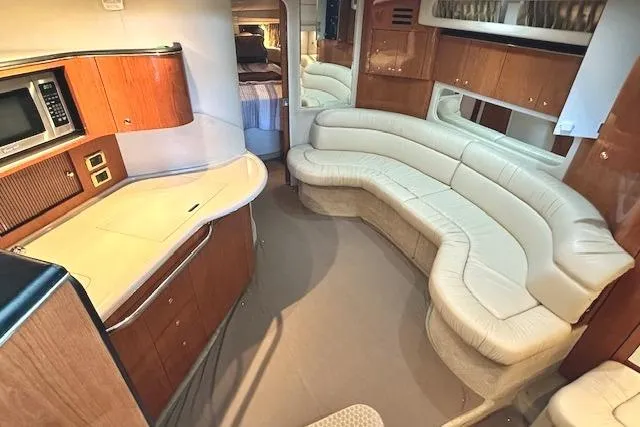 Slide: The Image of Luxurious interior of a 2001 Sea Ray 380 Sundancer yacht with curved seating and kitchenette. - 15