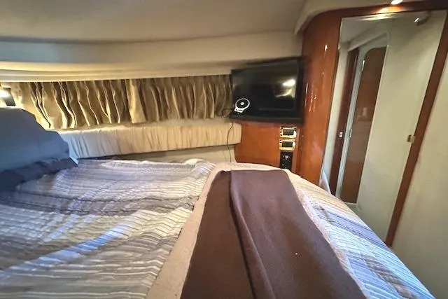 Slide: The Image of Interior cabin of 2001 Sea Ray 380 Sundancer yacht with bed and TV. - 20