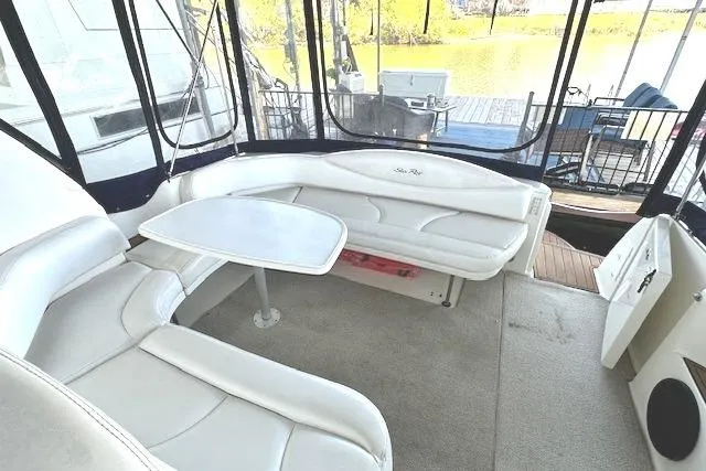 Slide: The Image of Interior view of 2001 Sea Ray 380 Sundancer with white seating and table. - 25