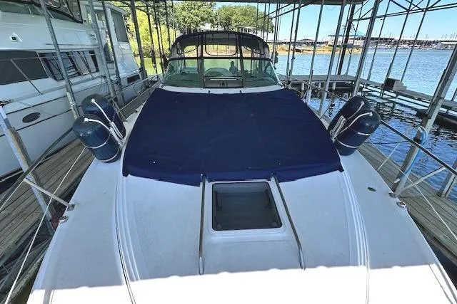 Slide: The Image of 2001 Sea Ray 380 Sundancer docked, covered deck, marina background. - 27