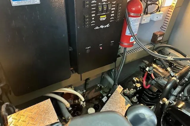 Slide: The Image of Engine room of 2001 Sea Ray 380 Sundancer with control panel and fire extinguisher. - 31