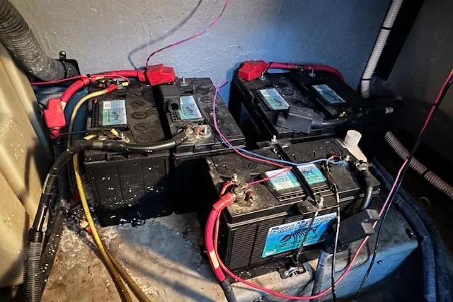 Slide: The Image of Battery compartment of a 2001 Sea Ray 380 Sundancer with multiple connected batteries. - 36